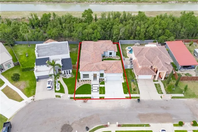 an aerial view of residential house with outdoor space and swimming pool