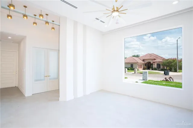a view of a room with wooden floor and a floor to ceiling window