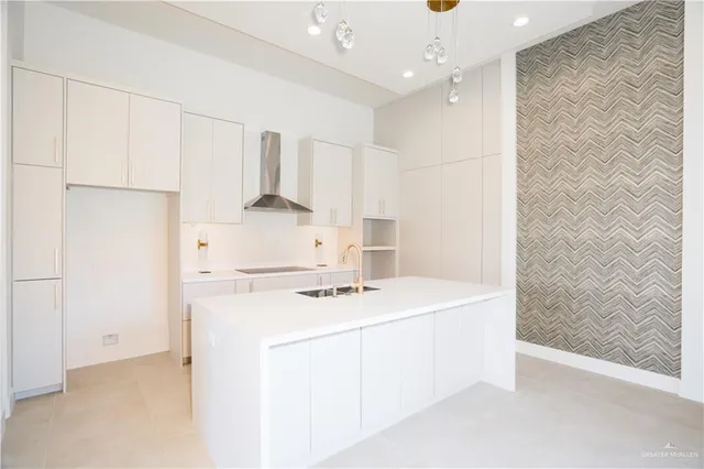 a kitchen with a sink a stove and refrigerator