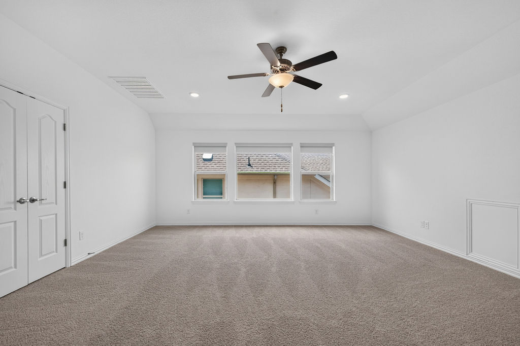1332 Ridge Runner Drive Georgetown, TX 78628 - Photo 25 of 40 A spacious room offers comfortable carpeting, recessed lighting, and a ceiling fan for year-round comfort.