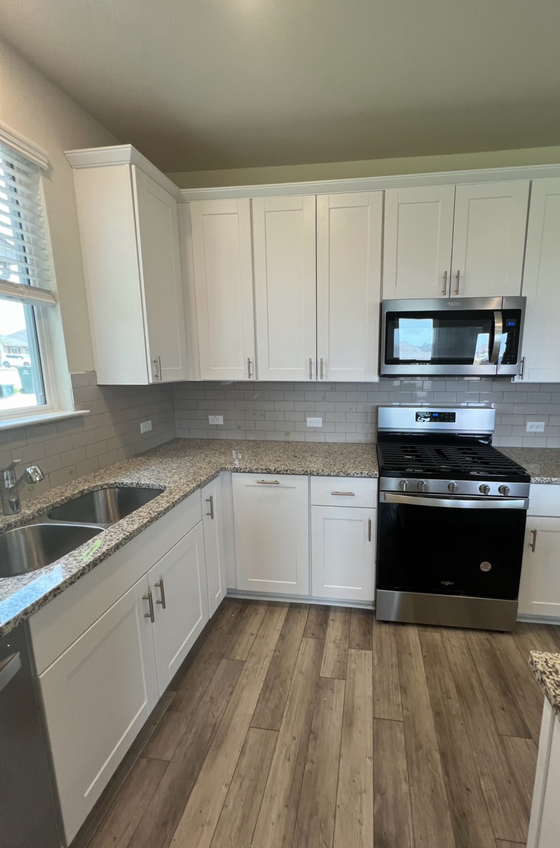 499 Tree Nut Loop Buda, TX 78610 - Photo 7 of 33 Kitchen has a huge pantry, white cabinets with sleek countertops and ample cabinetry for effortless meal preparation.