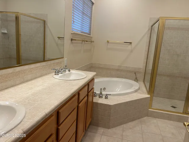 a bathroom with a tub sink and mirror