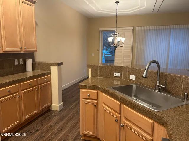 a kitchen with sink cabinets and appliances