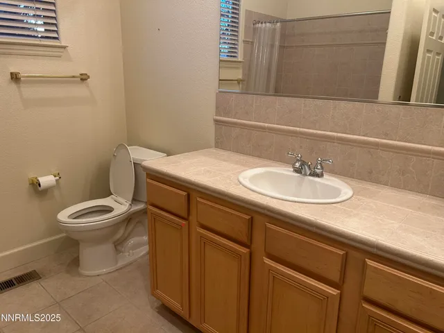a bathroom with a sink a toilet and mirror