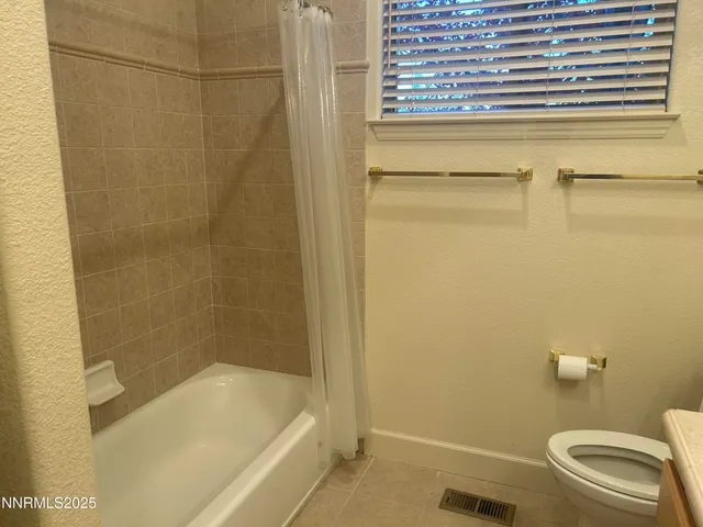 a bathroom with a bathtub and a toilet