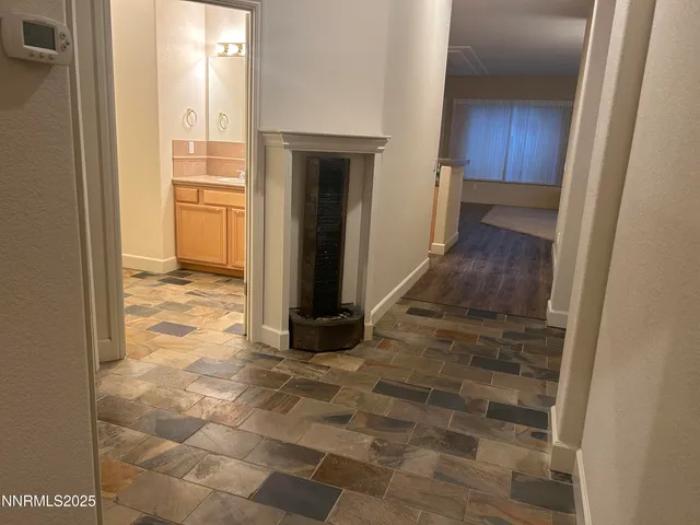 a view of a hallway with a wooden cabinets