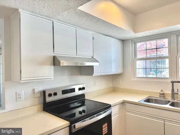 a kitchen with a sink and refrigerator