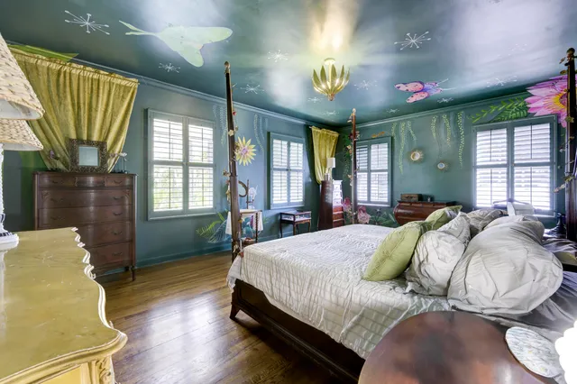 a bed sitting in a bedroom next to a window