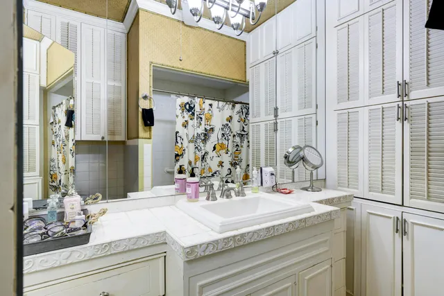 a bathroom with a granite countertop sink and a mirror
