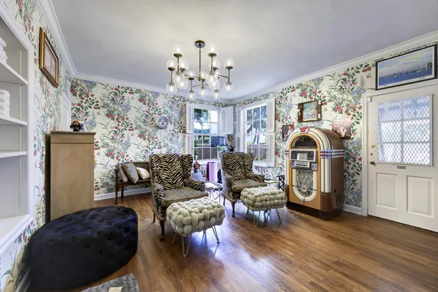 a living room with furniture a fireplace and wooden floor