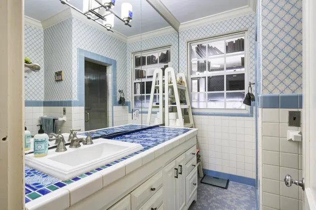 a bathroom with a sink a vanity and a mirror