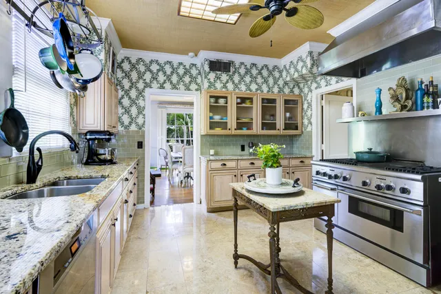 a kitchen with stainless steel appliances granite countertop a stove and a sink