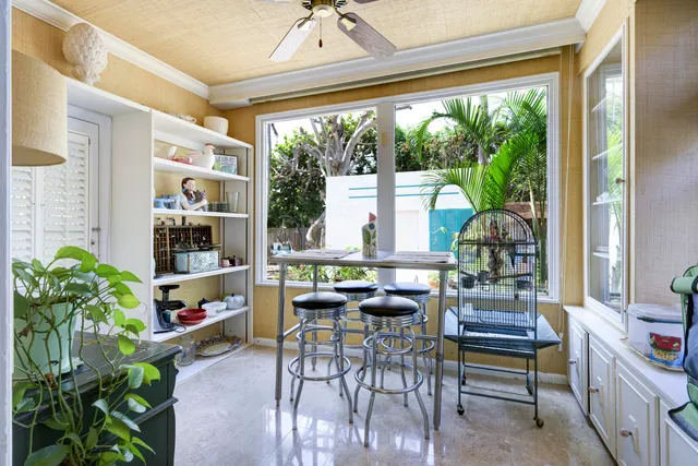 a living room with furniture and a potted plant