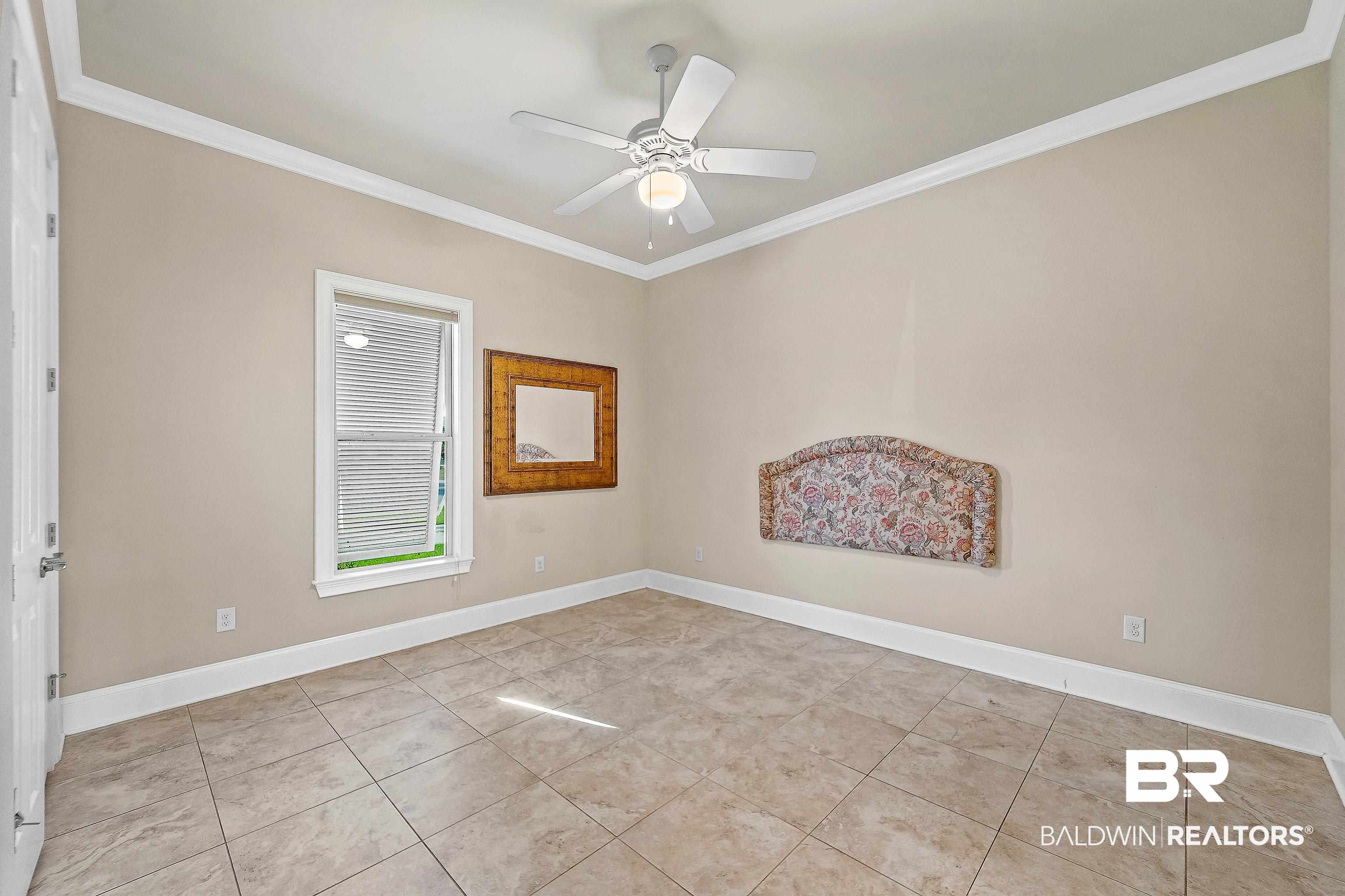 17663 Burwick Loop Fairhope, AL 36532 - Photo 22 of 41 Tiled spare room featuring ceiling fan and crown molding