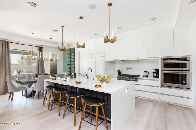 a kitchen with a refrigerator and a table