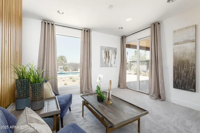 a bedroom with a bed and a large window