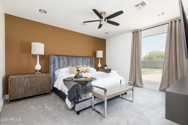 a bedroom with a bed and a lamp on table