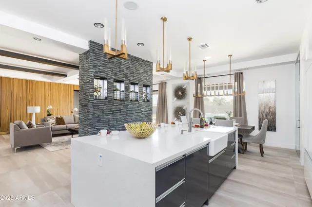 a kitchen with a sink a counter and chairs