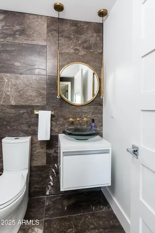 a living room with furniture and paintings on the wall