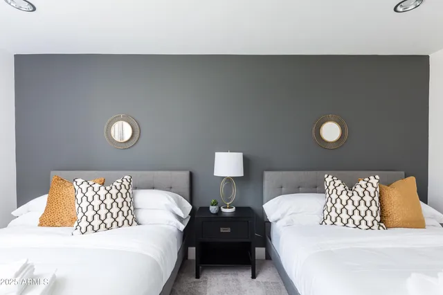 a bathroom with a double vanity sink mirror and shower