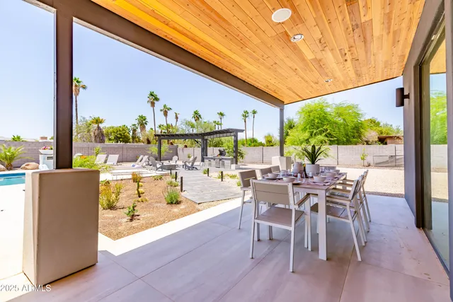 a view of swimming pool with lounge chair in the patio
