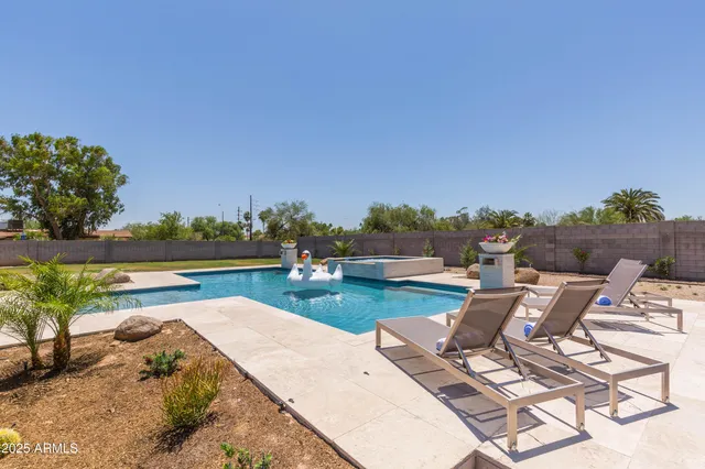 a view of a backyard and swimming pool