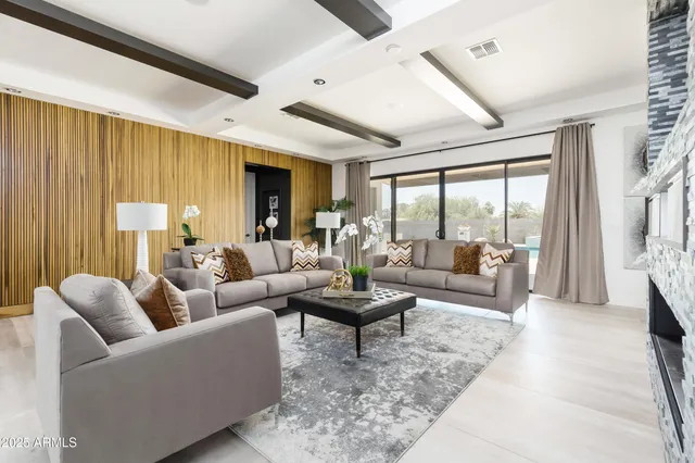 a living room with furniture and a large window