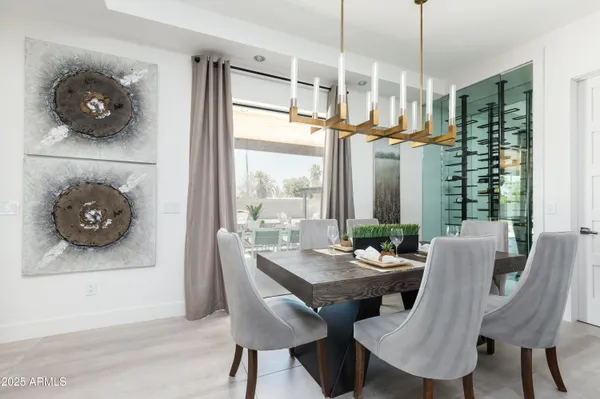 a kitchen with stainless steel appliances kitchen island granite countertop a stove a sink and a dining table with wooden floor
