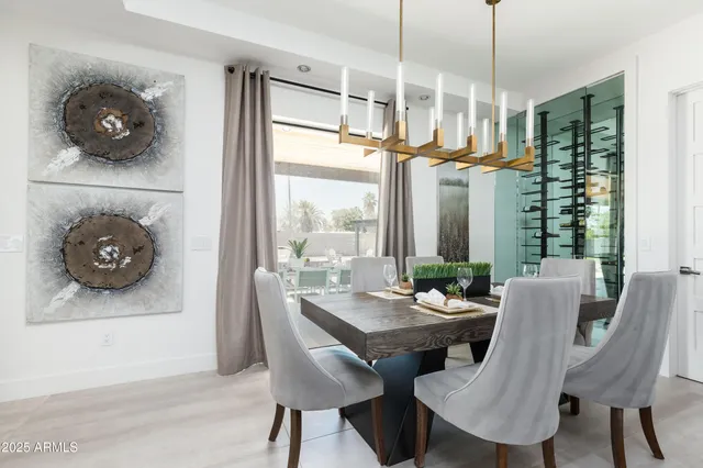 a kitchen with stainless steel appliances kitchen island granite countertop a stove a sink and a dining table with wooden floor