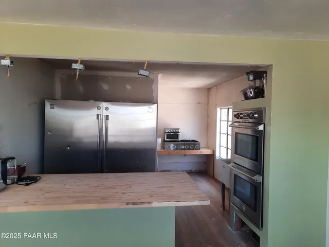 a kitchen with granite countertop a refrigerator and a sink