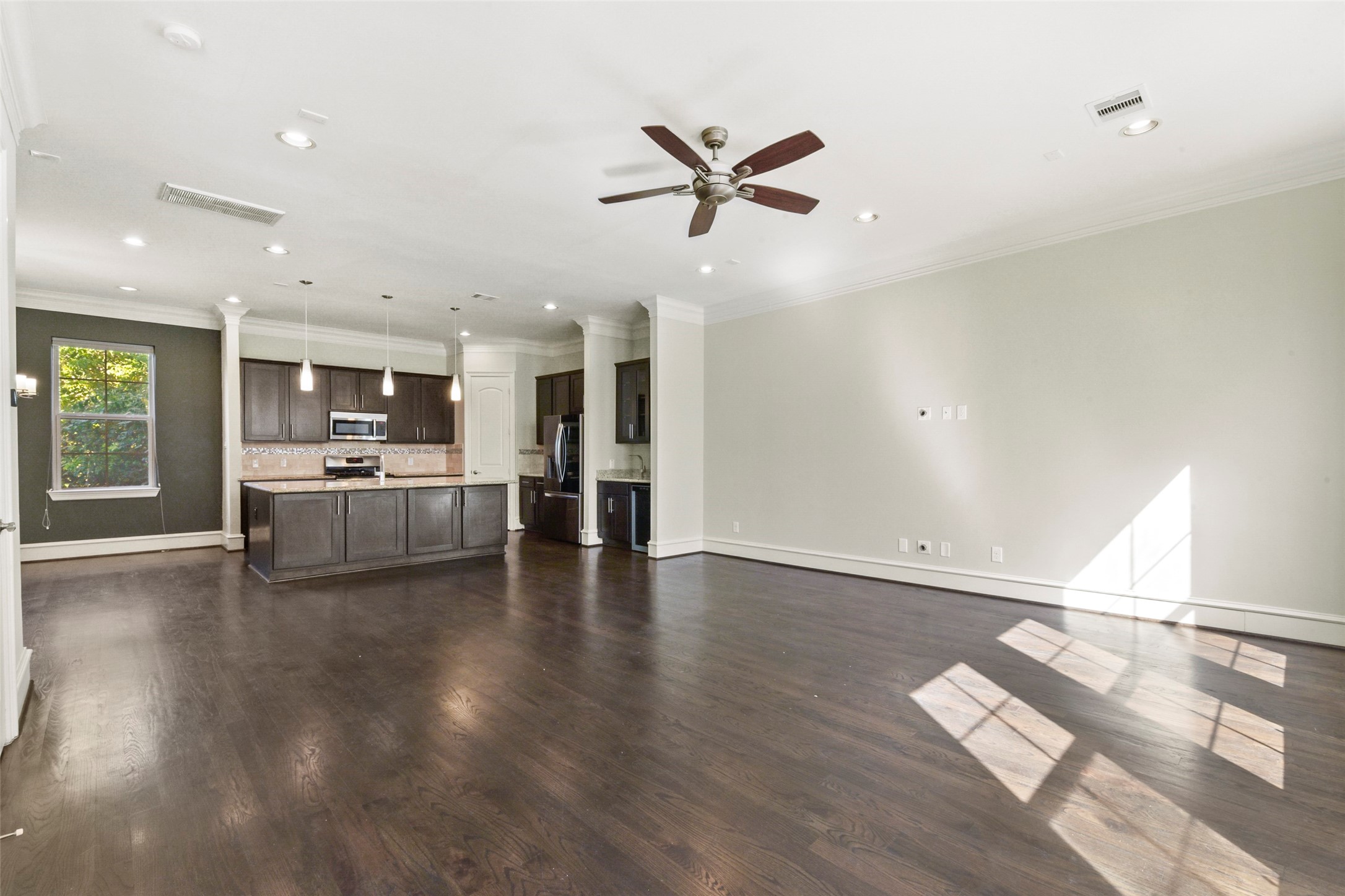 5226 Kiam Street, Unit 1018 Houston, TX 77007 - Photo 16 of 44 a view of a living room with wooden floor and a window