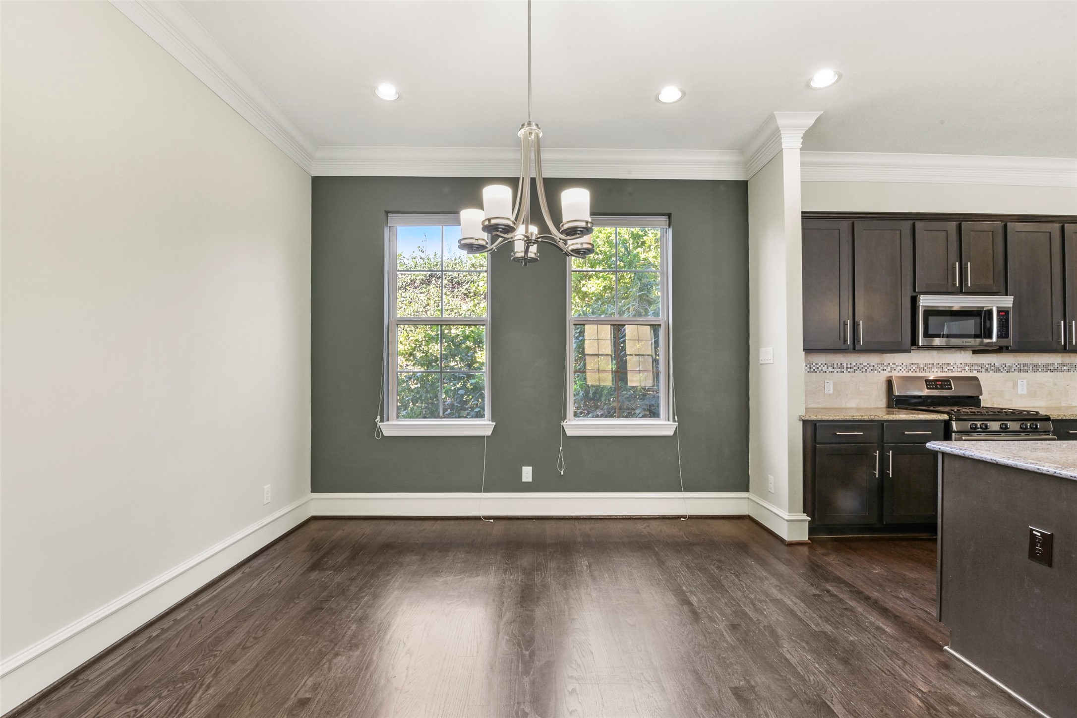 5226 Kiam Street, Unit 1018 Houston, TX 77007 - Photo 19 of 44 a kitchen with stainless steel appliances granite countertop a stove top oven a refrigerator with wooden floors and cabinets