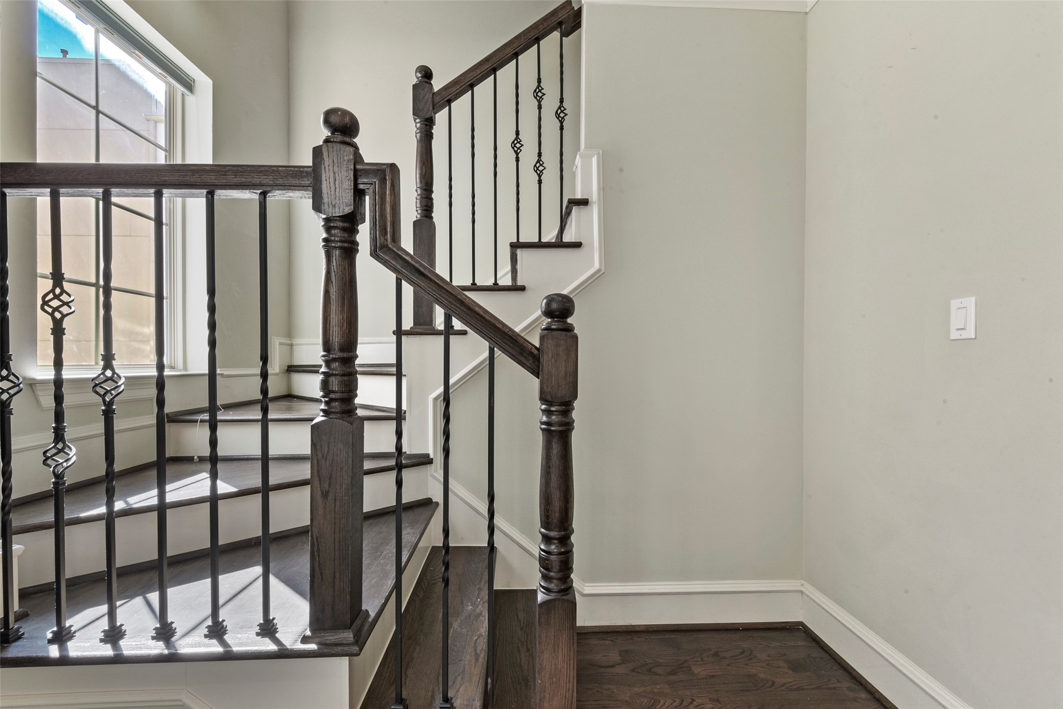 5226 Kiam Street, Unit 1018 Houston, TX 77007 - Photo 23 of 44 a view of staircase with lots of frames on wall and a window