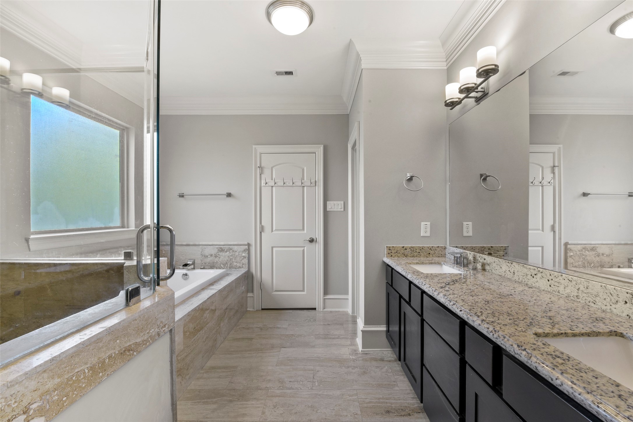 5226 Kiam Street, Unit 1018 Houston, TX 77007 - Photo 27 of 44 a spacious bathroom with a granite countertop double vanity sink a mirror and shower