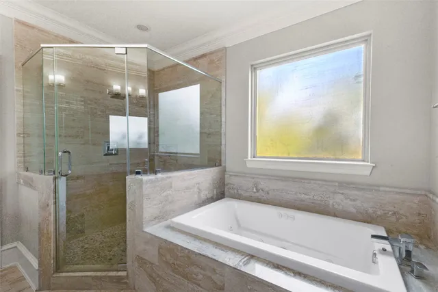 a bathroom with a bathtub and shower