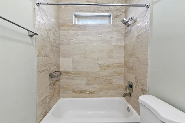 a bathroom with a shower and a toilet