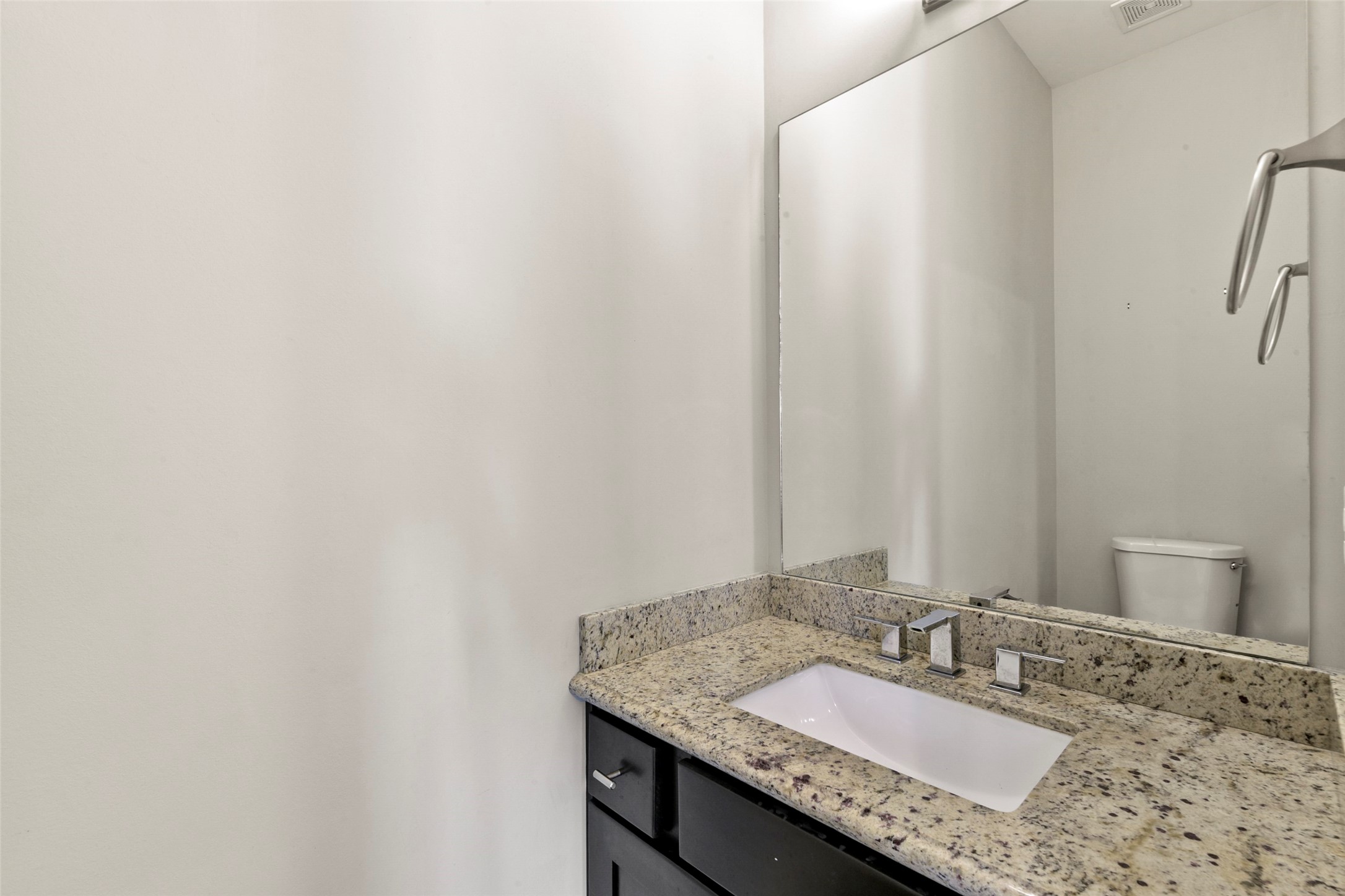 5226 Kiam Street, Unit 1018 Houston, TX 77007 - Photo 35 of 44 a bathroom with a granite countertop sink and a mirror