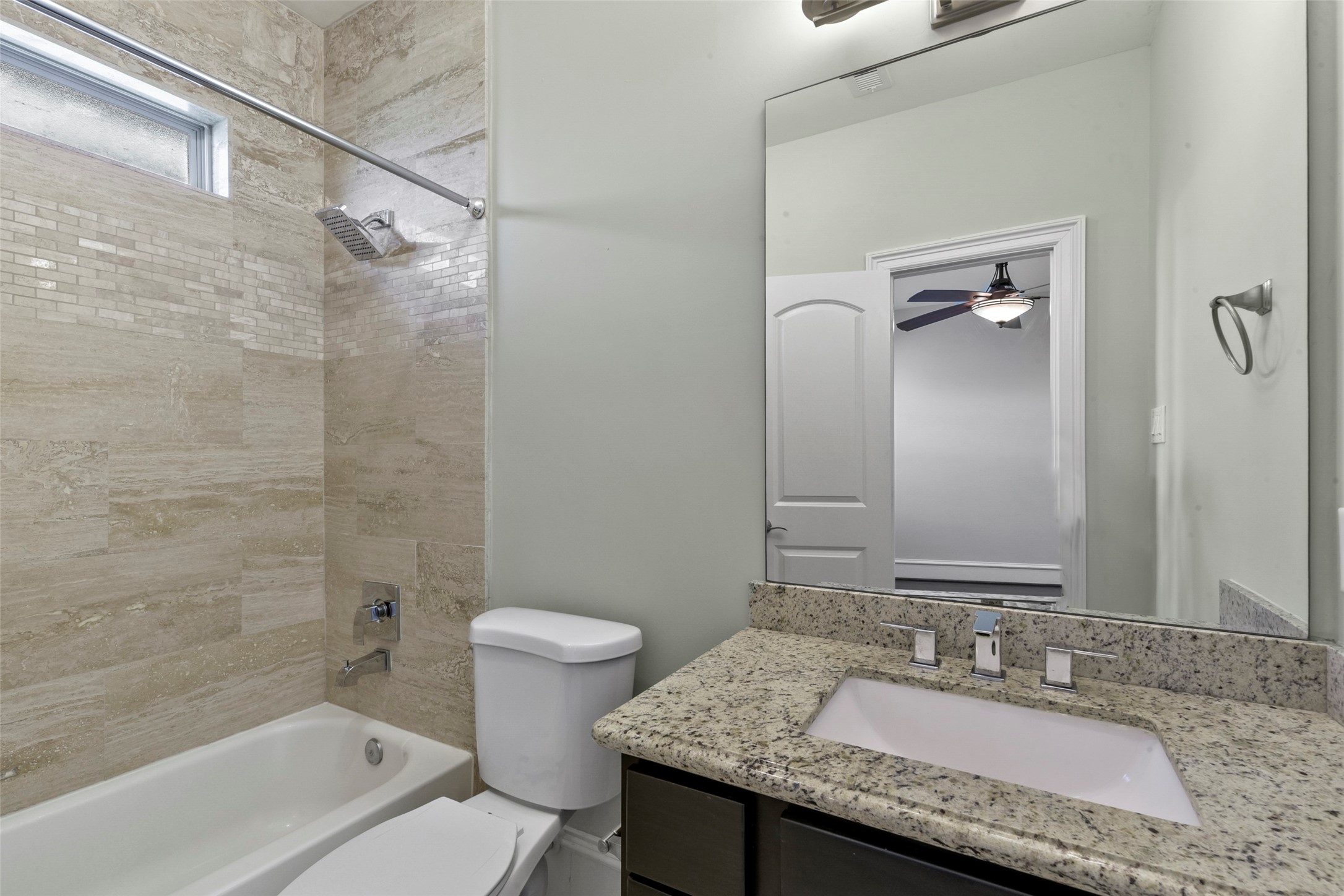 5226 Kiam Street, Unit 1018 Houston, TX 77007 - Photo 36 of 44 a bathroom with a granite countertop sink toilet and shower