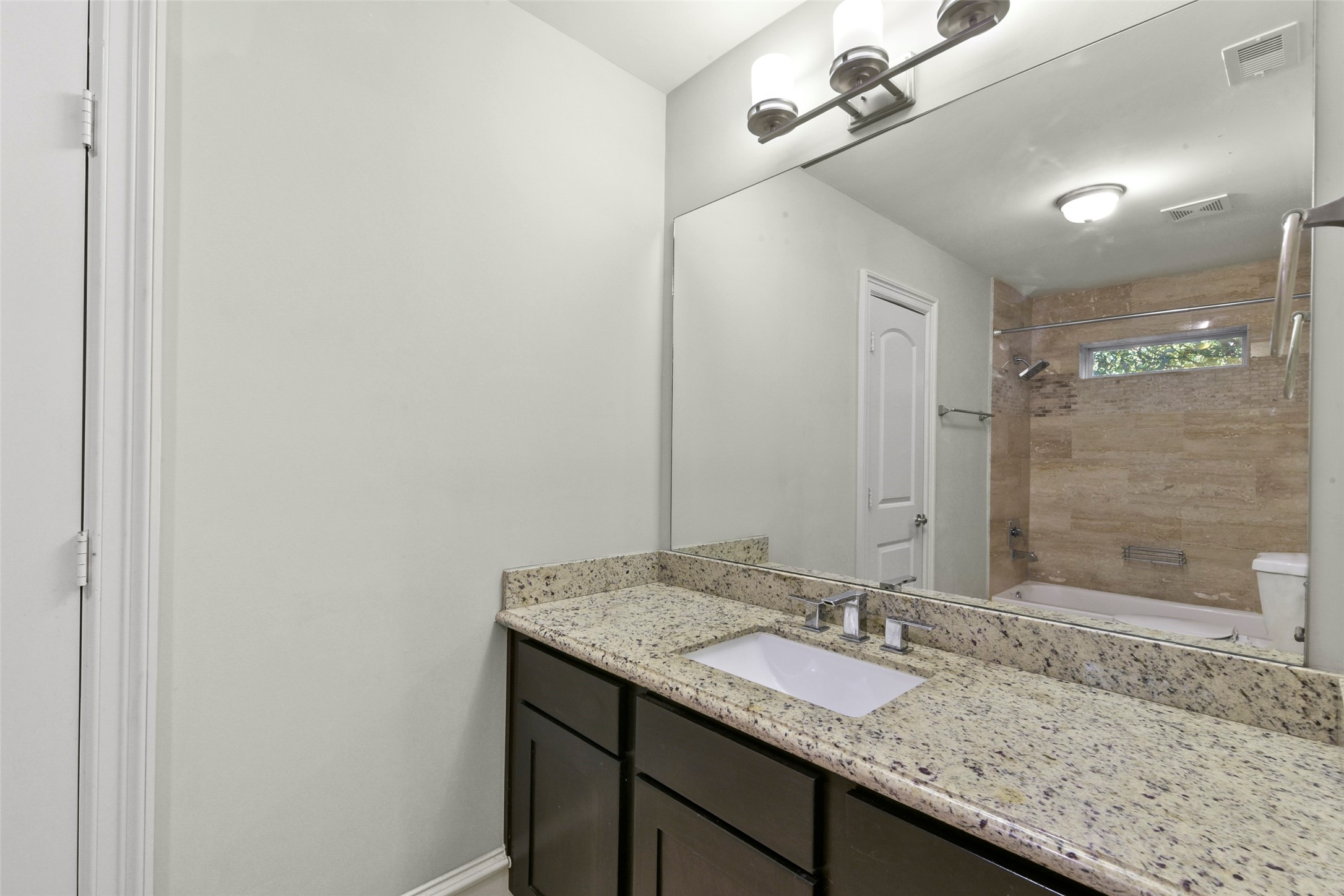 5226 Kiam Street, Unit 1018 Houston, TX 77007 - Photo 8 of 44 a bathroom with a granite countertop sink and a mirror