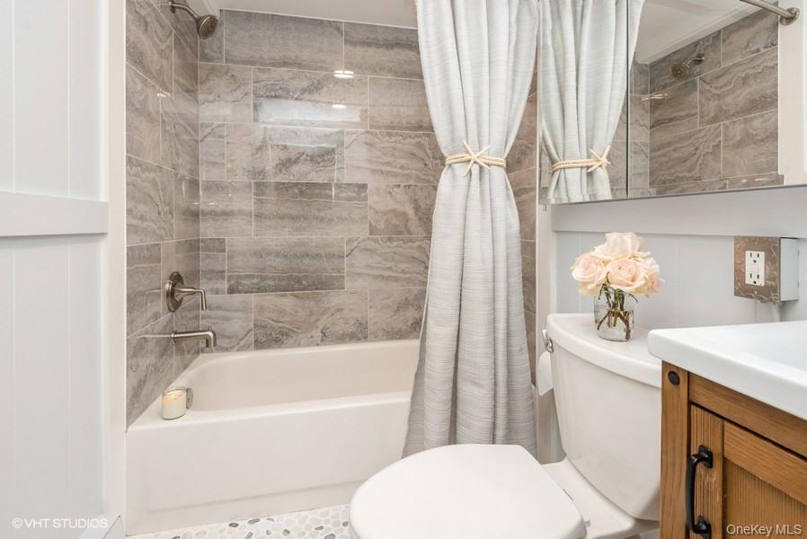 10 Stuart Avenue Babylon, NY 11702 - Photo 18 of 32 a bathroom with a sink a toilet and bathtub