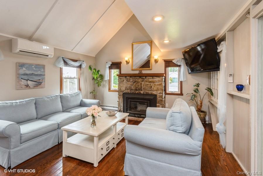 10 Stuart Avenue Babylon, NY 11702 - Photo 19 of 32 a living room with furniture a fireplace and a flat screen tv