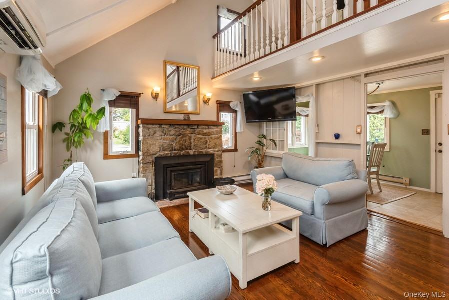 10 Stuart Avenue Babylon, NY 11702 - Photo 20 of 32 a living room with furniture a fireplace and a large window
