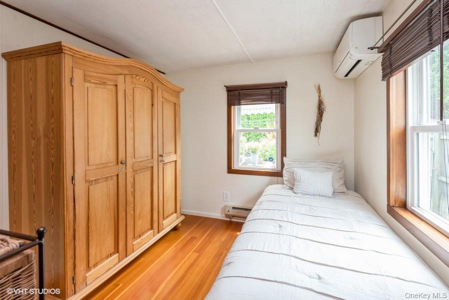 10 Stuart Avenue Babylon, NY 11702 - Photo 24 of 32 a view of a bedroom with wooden floor and windows