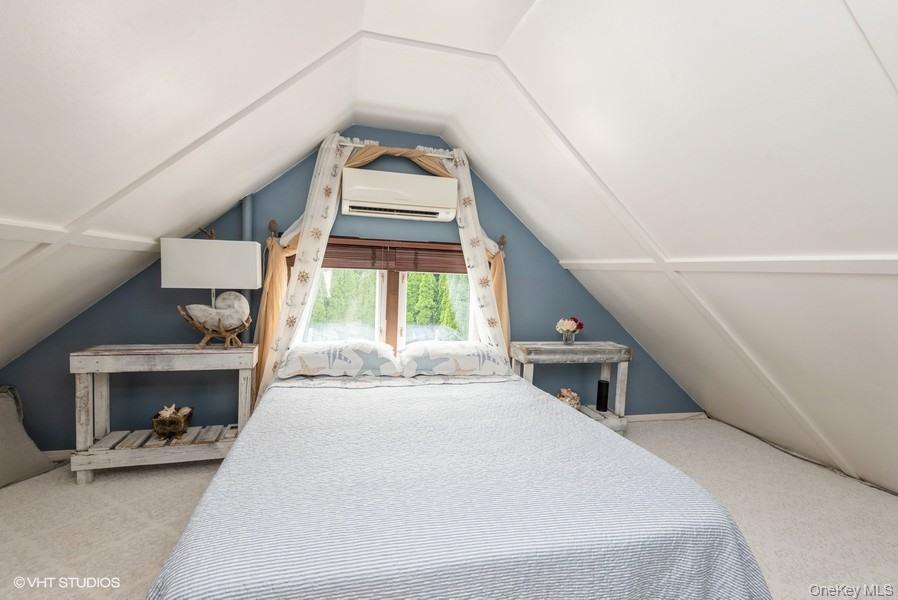 10 Stuart Avenue Babylon, NY 11702 - Photo 26 of 32 a bedroom with a bed and a large window