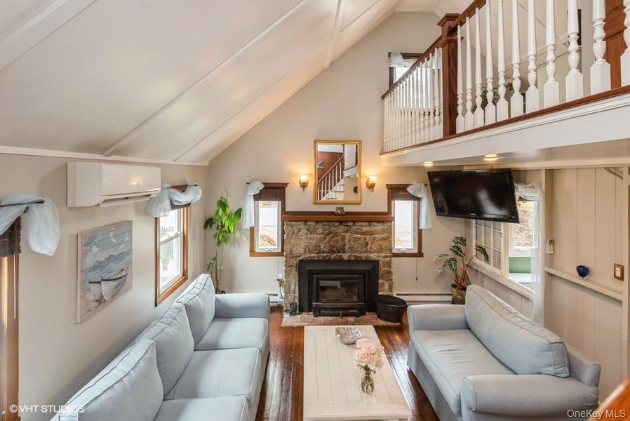 10 Stuart Avenue Babylon, NY 11702 - Photo 32 of 32 a living room with furniture a fireplace and a flat screen tv