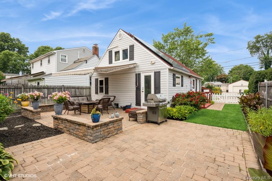 10 Stuart Avenue Babylon, NY 11702 - Photo 5 of 32 a view of a white house with a yard and plants