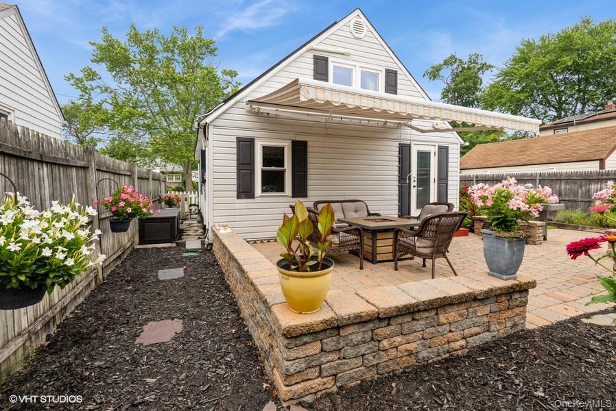 10 Stuart Avenue Babylon, NY 11702 - Photo 7 of 32 a view of a patio with couches table and chairs and potted plants