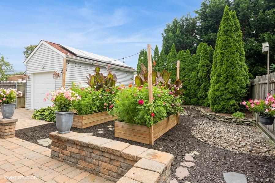 10 Stuart Avenue Babylon, NY 11702 - Photo 8 of 32 a house with a yard and potted plants