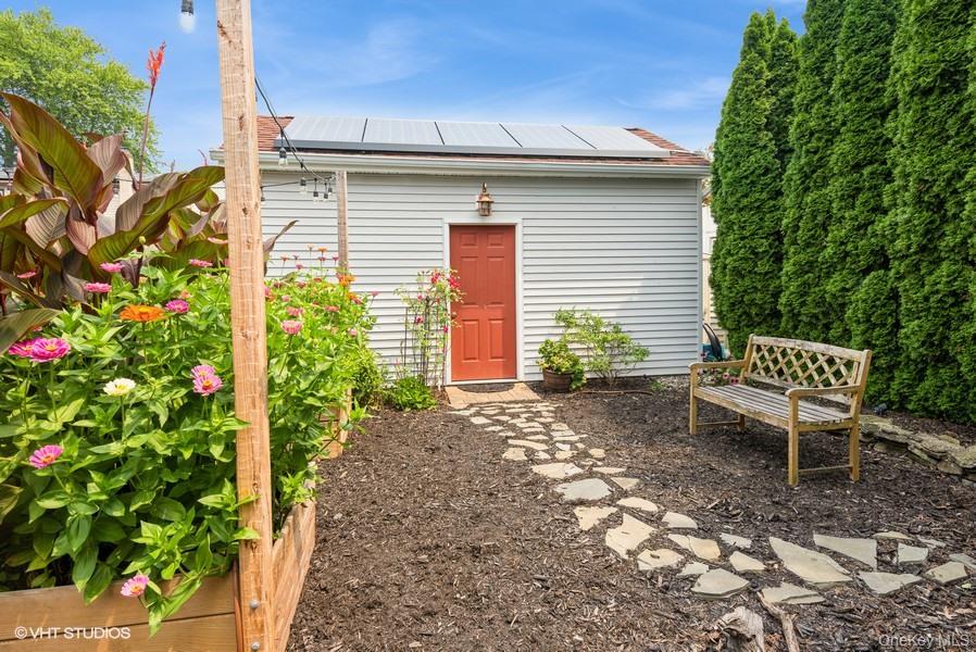 10 Stuart Avenue Babylon, NY 11702 - Photo 9 of 32 a backyard of a house with table and chairs