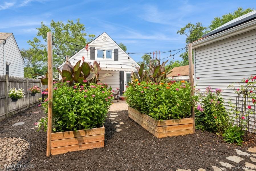 10 Stuart Avenue Babylon, NY 11702 - Photo 10 of 32 a front view of a house with a yard
